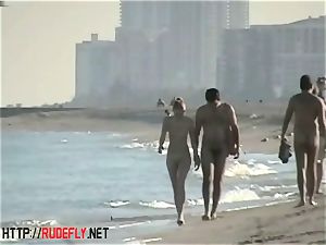peeping at a molten nudist couple on the beach